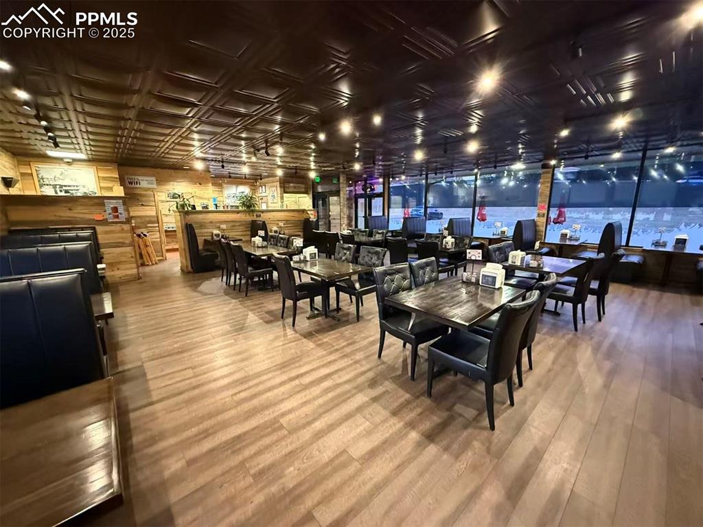 Image 5 of 10: Dining space featuring wood finished floors and an ornate ceiling