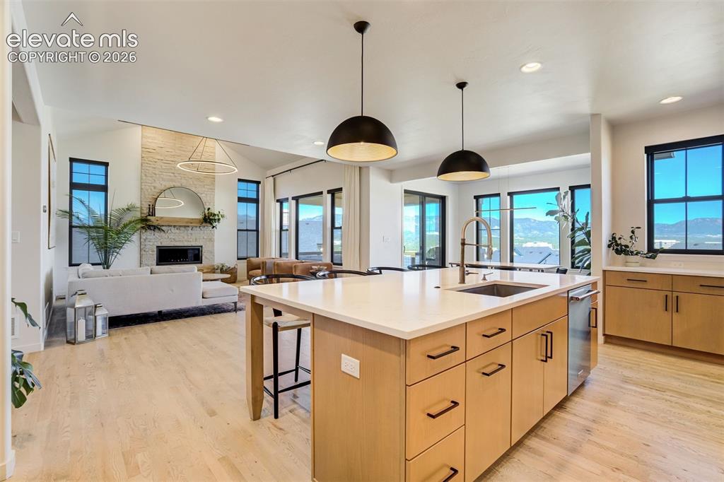 Image 13 of 50: Open-concept living space featuring a spacious kitchen island with integrat