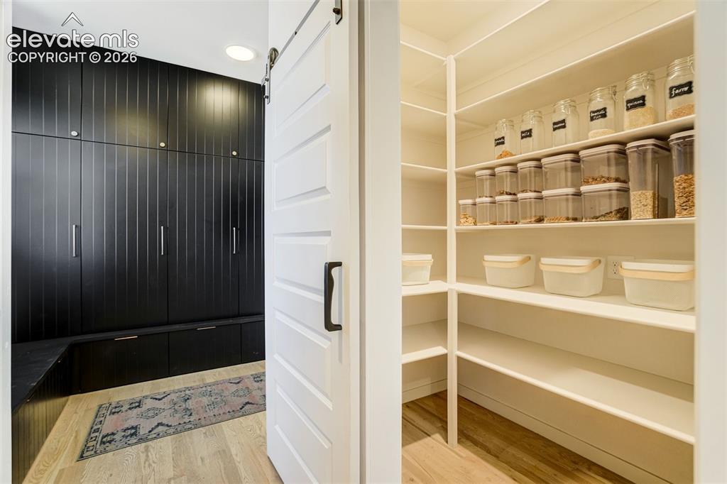 Image 18 of 50: Custom built-in cabinetry in a dark finish with integrated storage bench, w