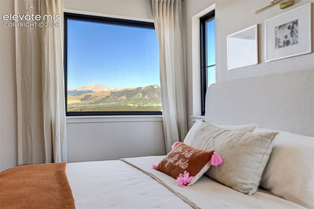 Image 22 of 50: Expansive window framing a mountain backdrop