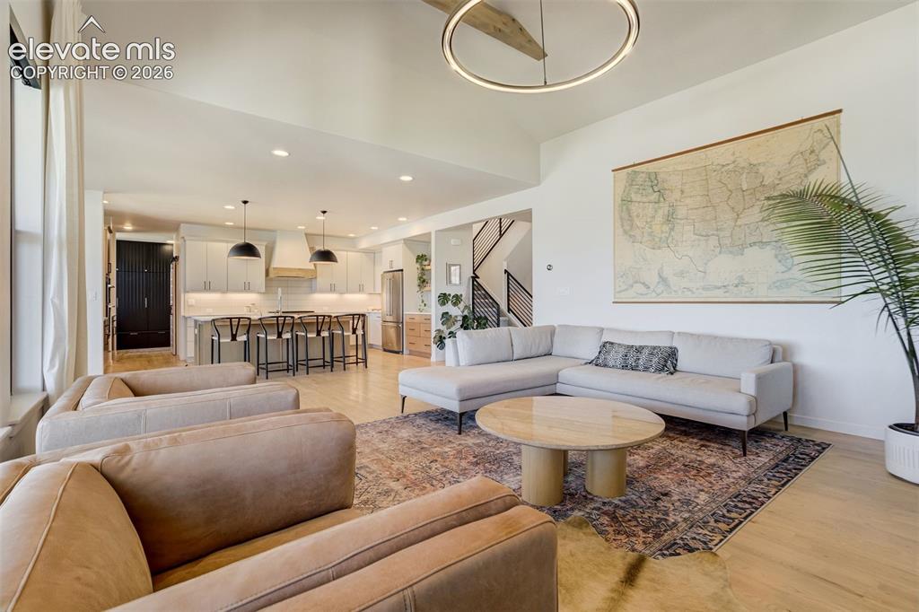 Image 7 of 50: Open concept living space featuring vaulted ceilings, light wood-finish flo