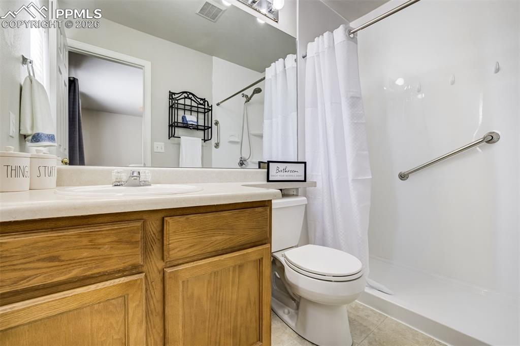 Image 21 of 33: Primary bathroom with zero transition shower.