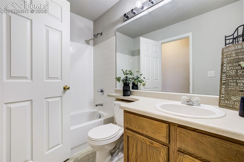 Image 29 of 33: FUll secondary bathroom with tub.
