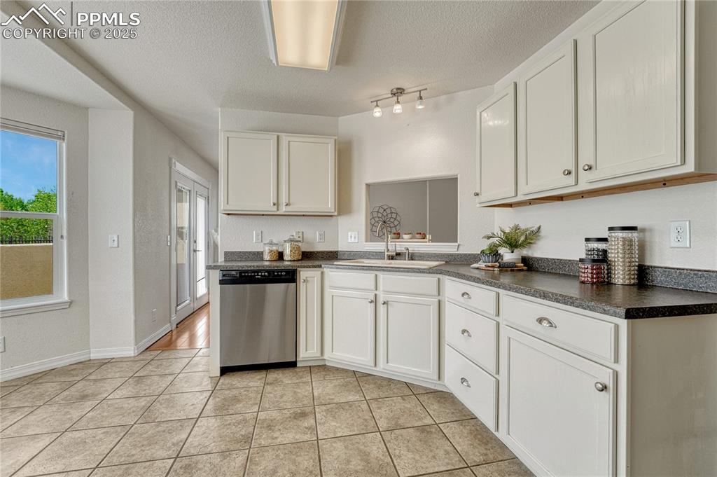 Image 10 of 47: The kitchen has a passthrough to the dining room along with two entry point