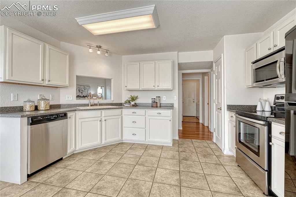 Image 11 of 47: Ceramic tile flooring, open layout and plenty of cabinet storage