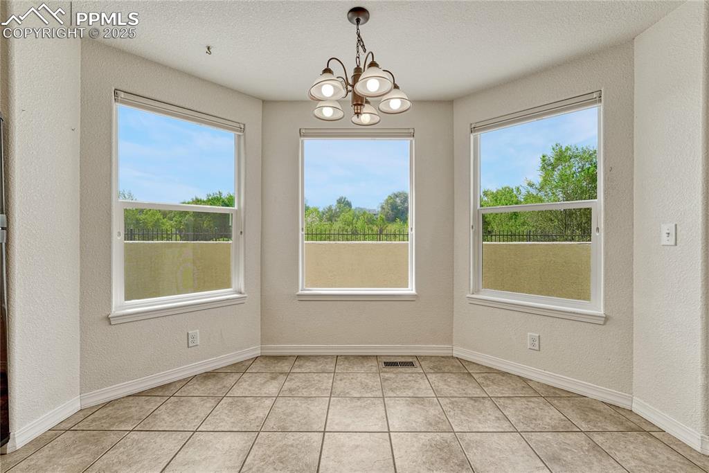 Image 13 of 47: Light filling the kitchen comes from a large second dining nook bump out