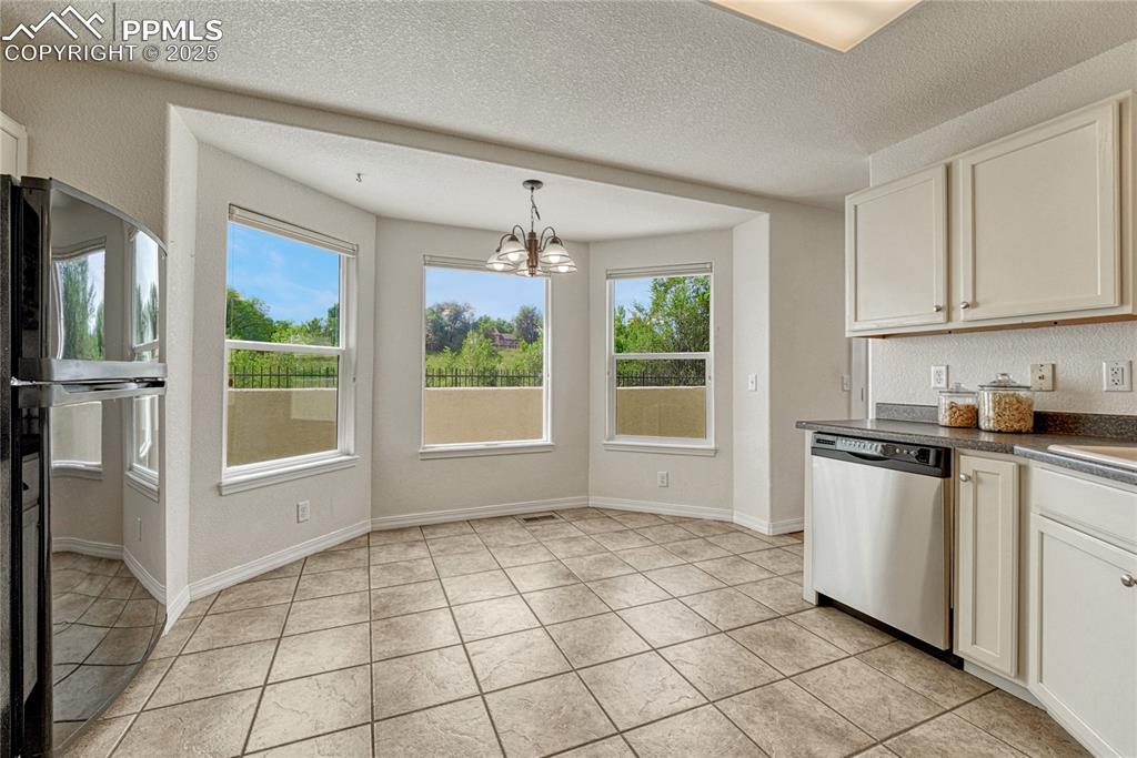 Image 14 of 47: The 3 large windows let you overlook the back patio and open space of Cotto