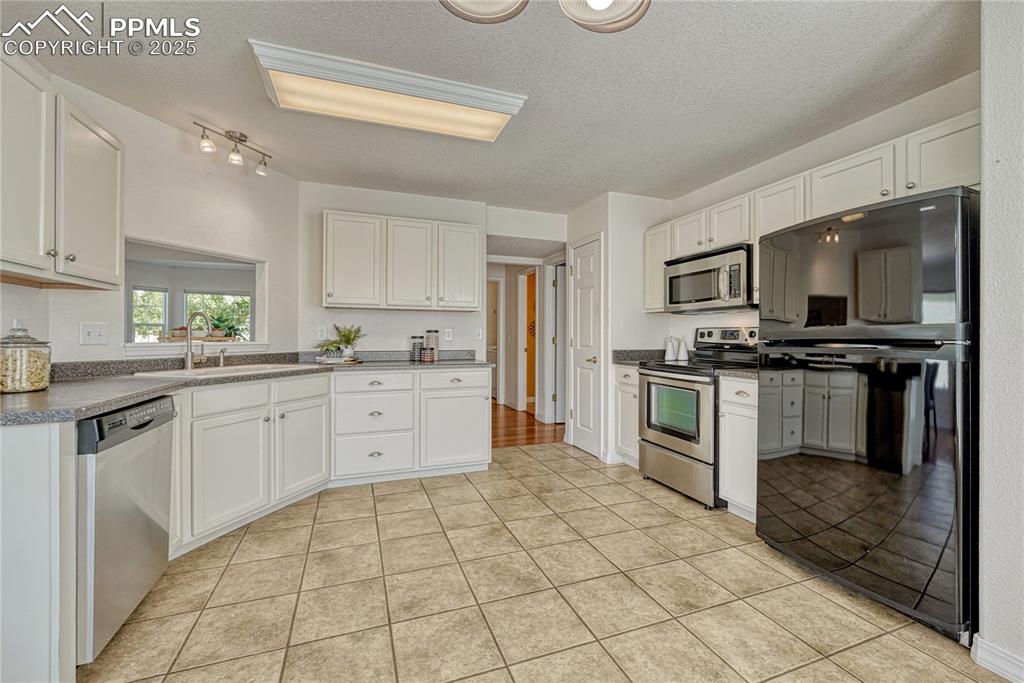 Image 15 of 47: Ample counter space and the layout makes the kitchen a place to cook and ea