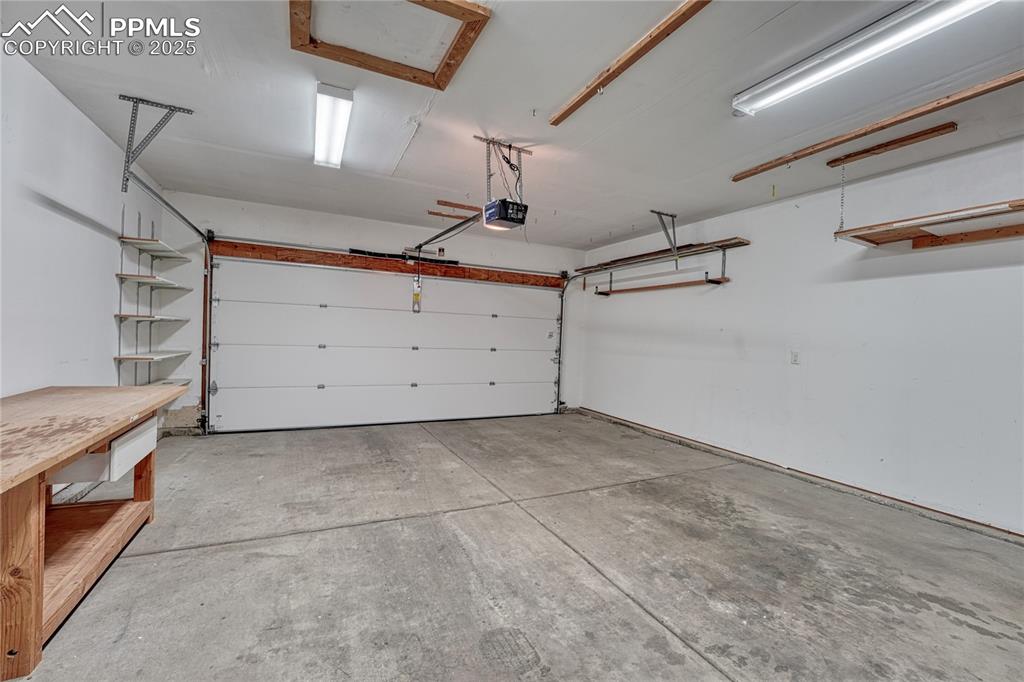 Image 17 of 47: Clean and finished 2-car garage with a garage opener along with access to t