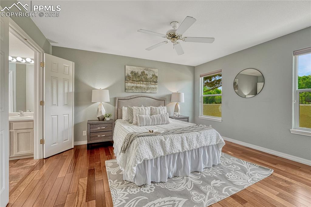 Image 20 of 47: Continue down the hall to the main-level primary bedroom suite