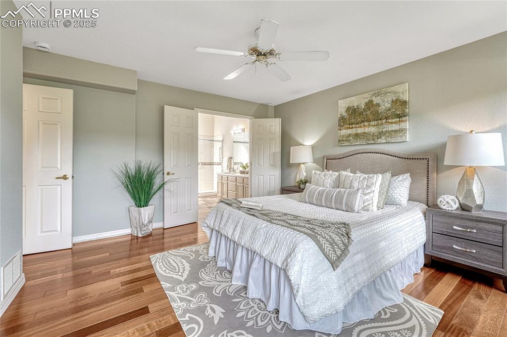Image 22 of 47: Adjoining the bedroom is double doors to the primary bathroom