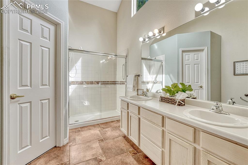 Image 23 of 47: Dual vanities, free standing shower and ceramic tile floors
