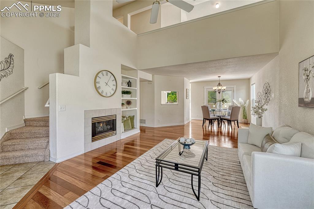 Image 25 of 47: Back to the living room and up the curved, carpeted stairs to the upper flo