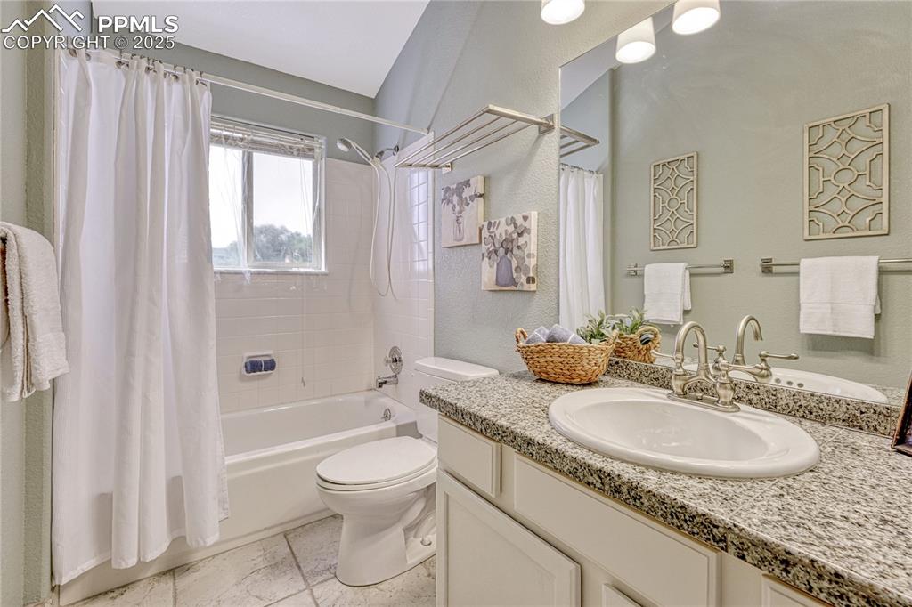 Image 32 of 47: The upper-level full bath with tile floors and vanity. Colors and finishes