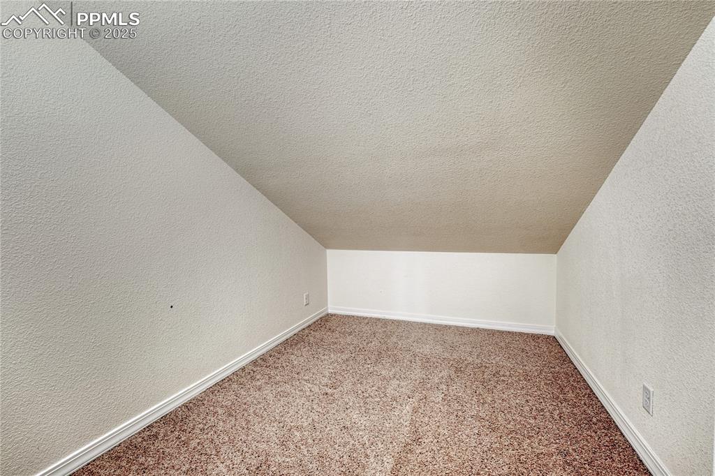 Image 33 of 47: Across the upper-level bath is a large storage closet that could also be a