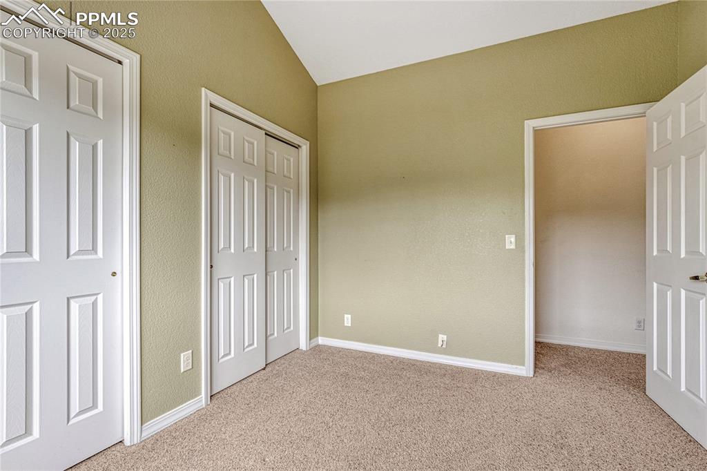 Image 34 of 47: At the end of the hall is the second upper-level bedroom with dual closets