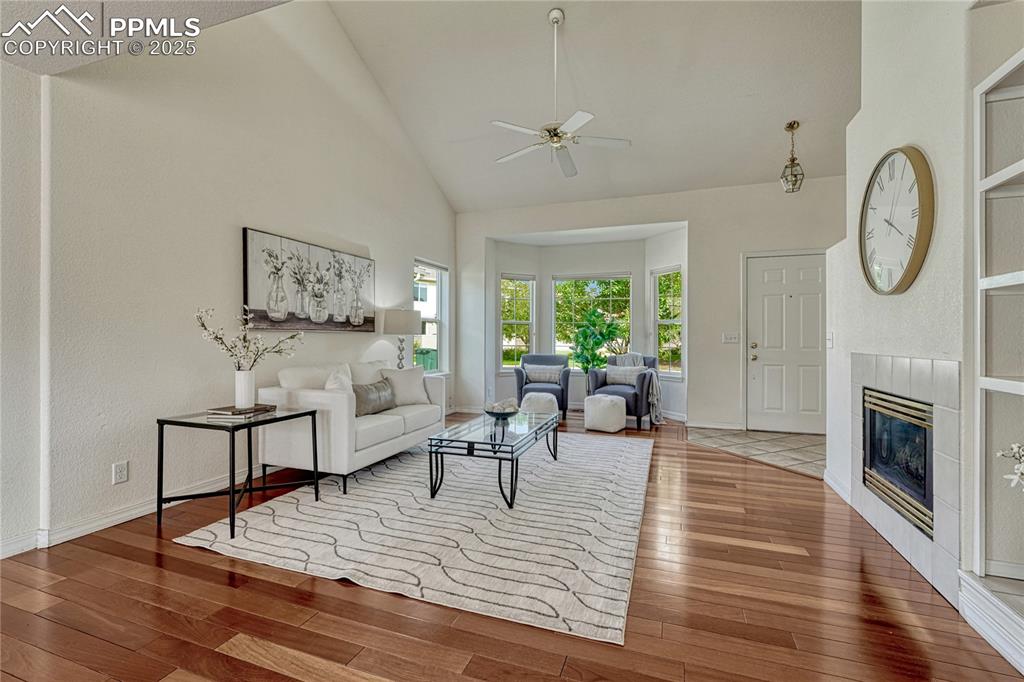 Image 5 of 47: Well-maintained home with hardwood floors, vaulted ceilings and a gas log f