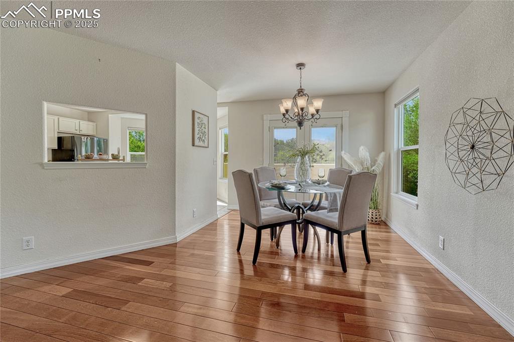 Image 7 of 47: The living room flows into the dining space with walkout access to the back