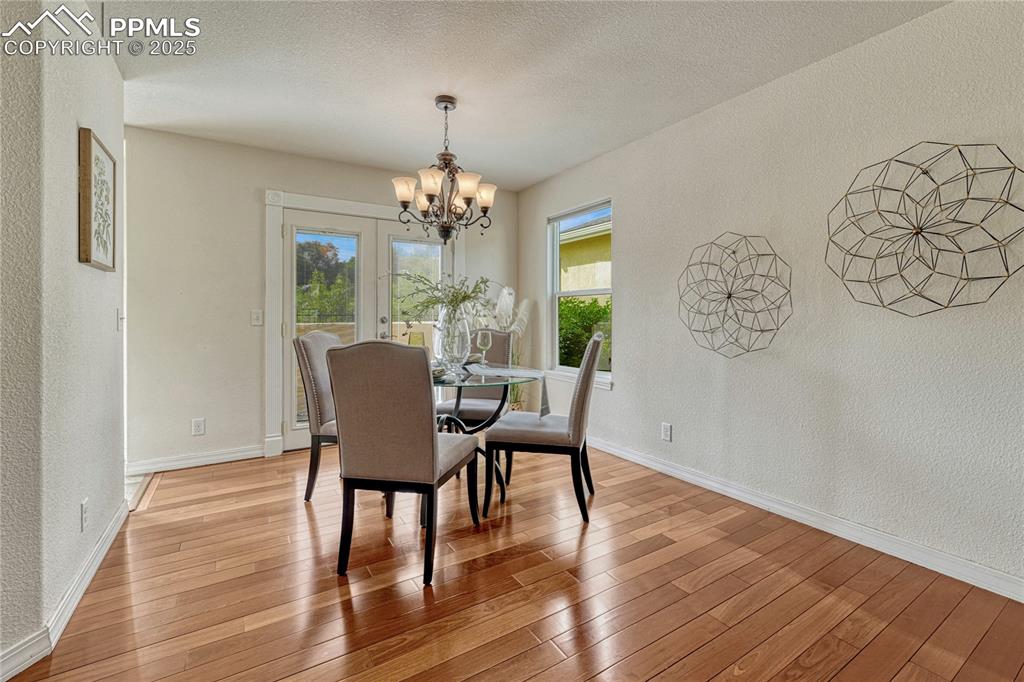 Image 8 of 47: The dining area has the same beautiful hardwood flooring along with an orna