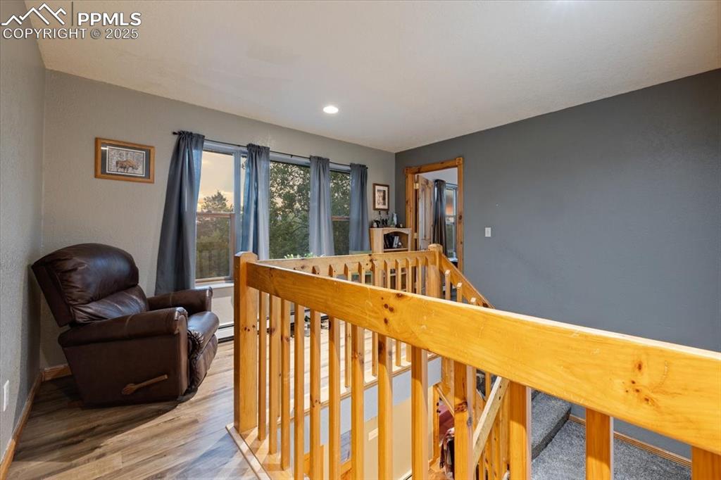 Image 30 of 47: Upper Loft/ Sitting area separating Primary bedroom and 2 spare beds and ba