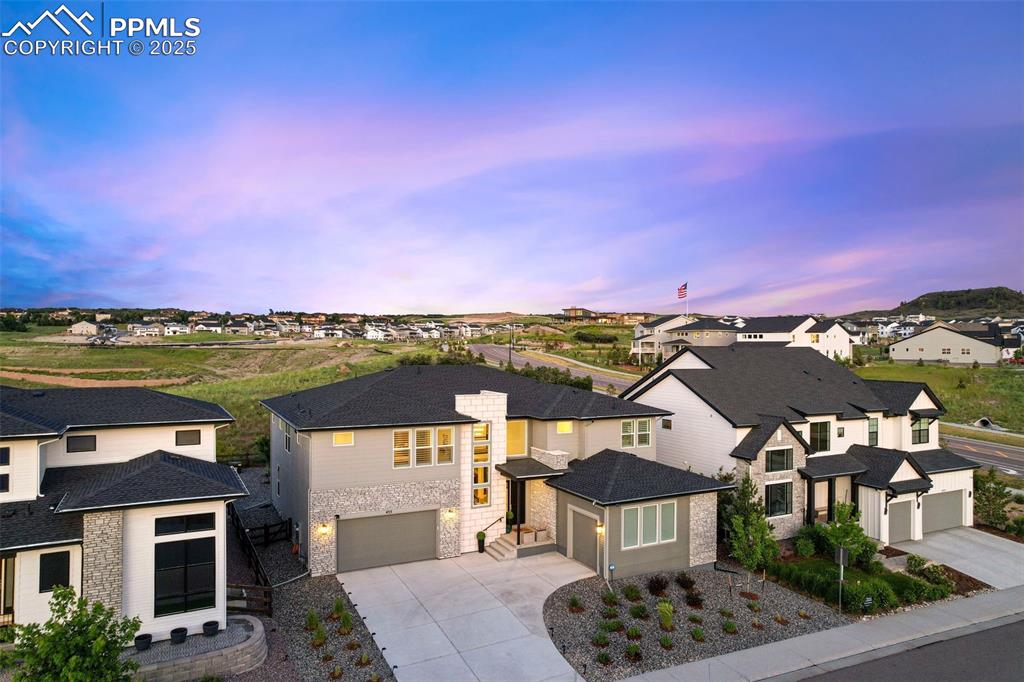 Caption: View of front of house featuring concrete driveway, a residential view, and a garage