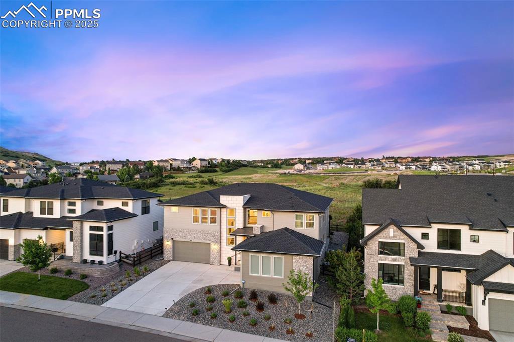 Image 2 of 49: View of front of house featuring a residential view, driveway, stone siding