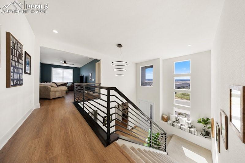 Image 23 of 49: Staircase with wood finished floors and baseboards