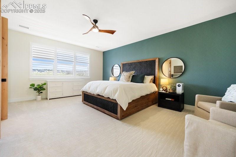 Image 24 of 49: Carpeted bedroom with a ceiling fan