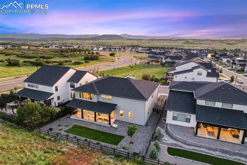 Image 3 of 49: Aerial view of residential area featuring a mountain backdrop