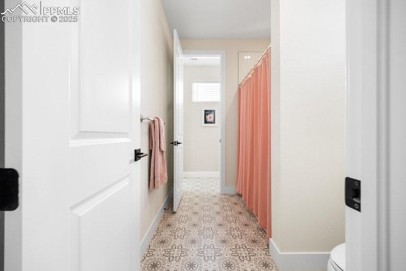 Image 32 of 49: Hallway featuring baseboards