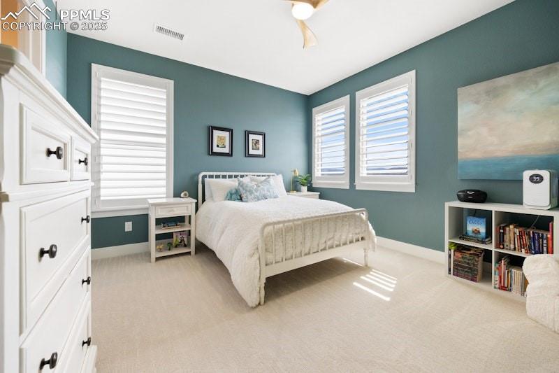 Image 36 of 49: Carpeted bedroom with baseboards and a ceiling fan