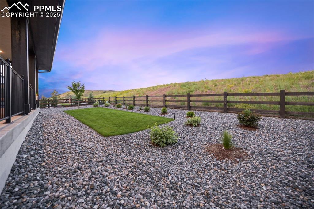 Image 5 of 49: View of fenced backyard