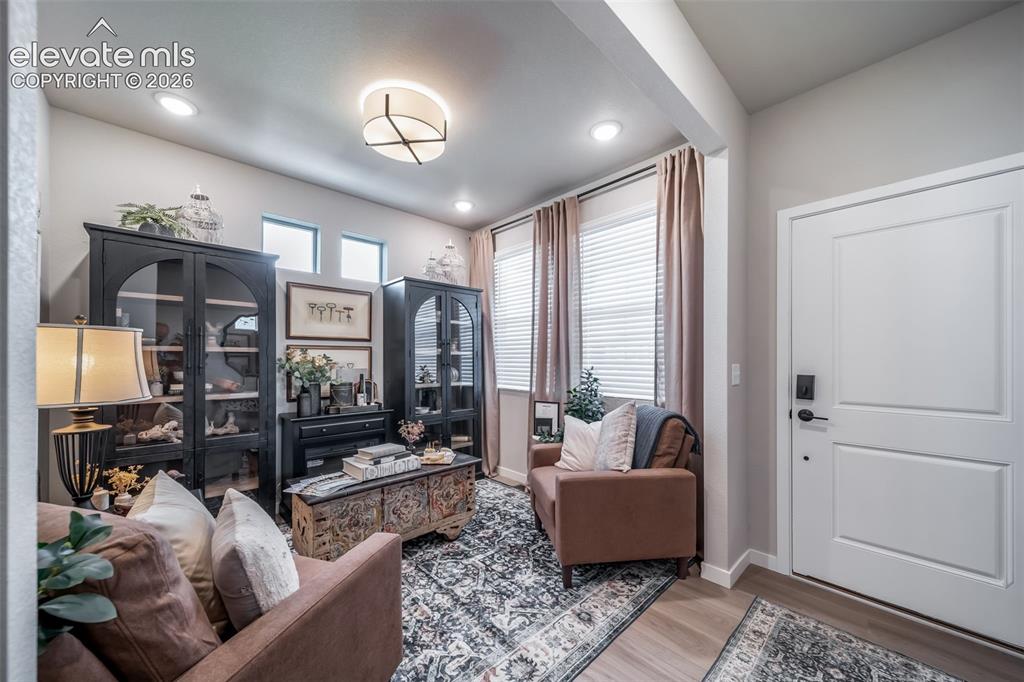 Image 17 of 45: Entryway featuring wood-finish flooring and a paneled door with matte black