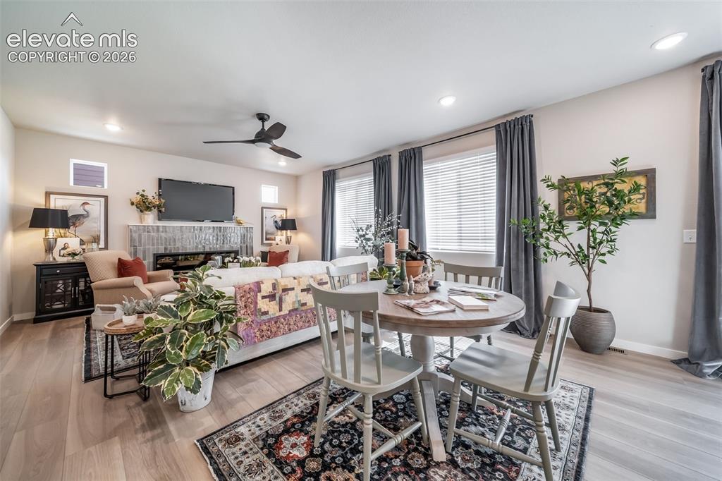 Image 26 of 45: Open-concept living space featuring wood-finish flooring and recessed light