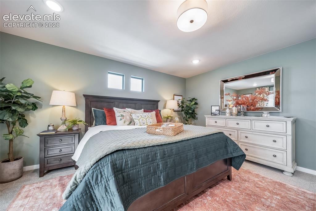 Image 40 of 45: Recessed ceiling lighting complements a central drum light fixture
*Photos