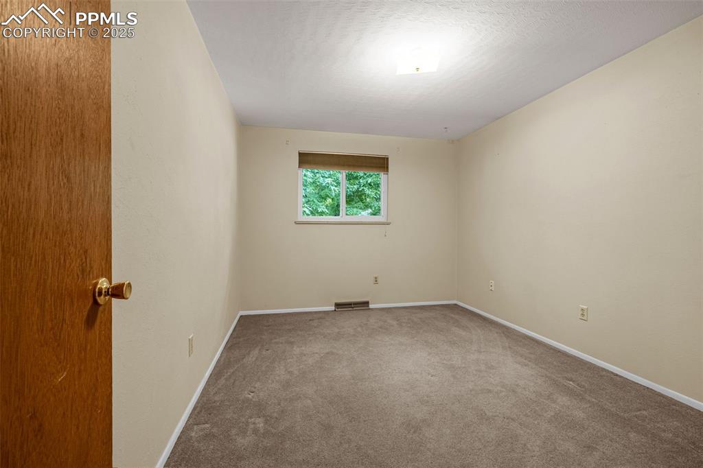 Image 10 of 19: Third bedroom with carpet.