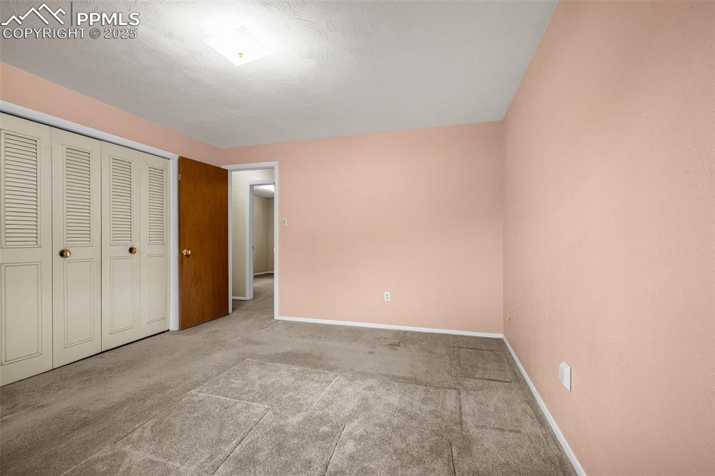 Image 12 of 19: Unfurnished bedroom with carpet and adequate closet space.