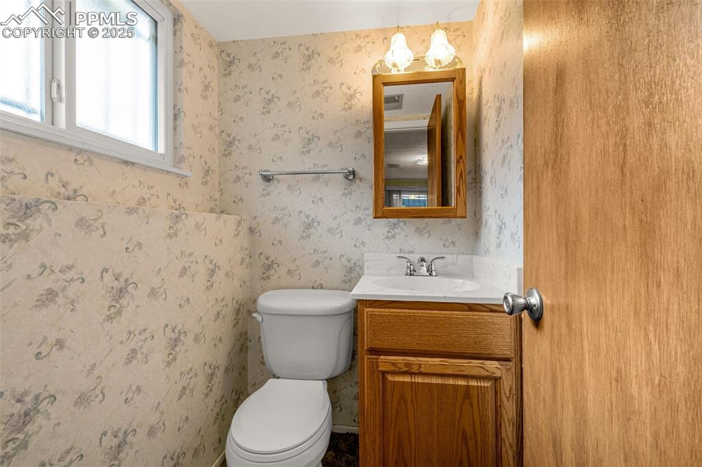 Image 15 of 19: Half bathroom in lower-level family room. 