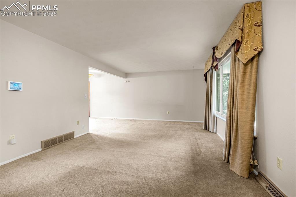 Image 3 of 19: Living room with carpet.