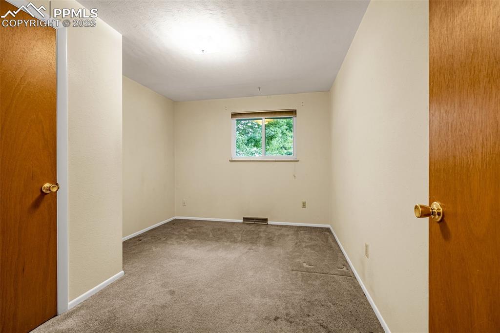Image 8 of 19: Carpeted secondary bedroom.