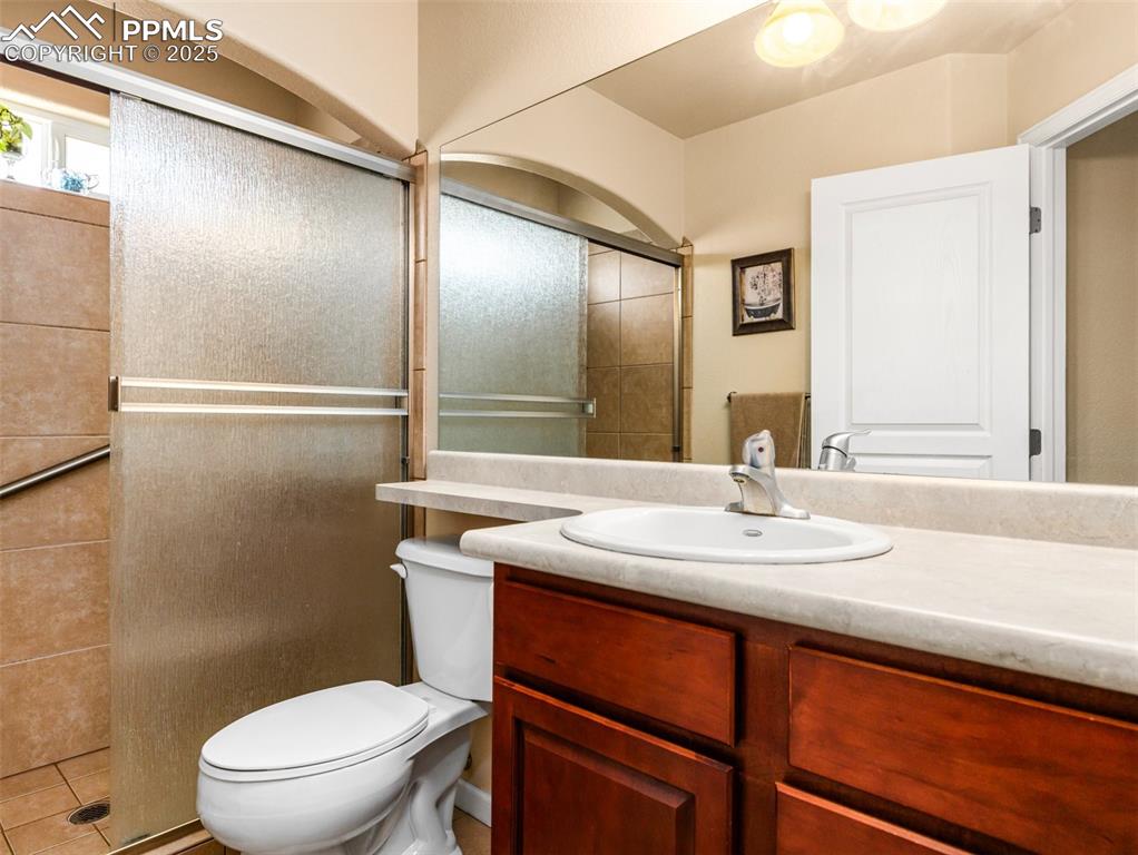 Image 19 of 48: Full bathroom with vanity and tiled shower
