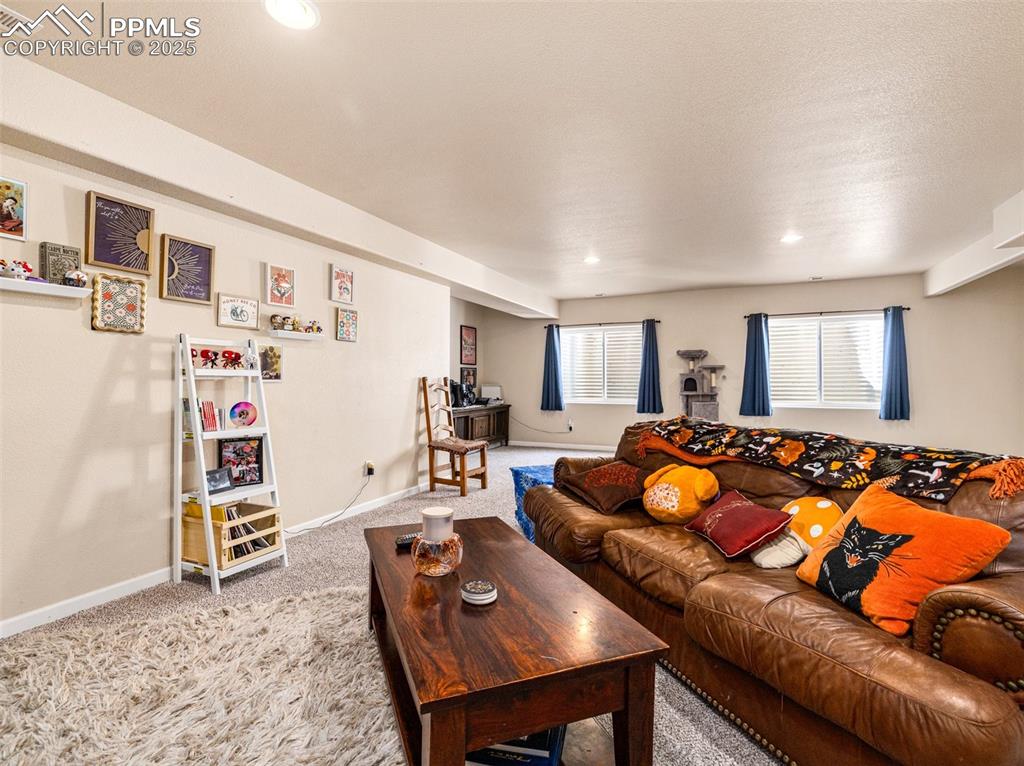 Image 28 of 48: Carpeted living room featuring baseboards and recessed lighting