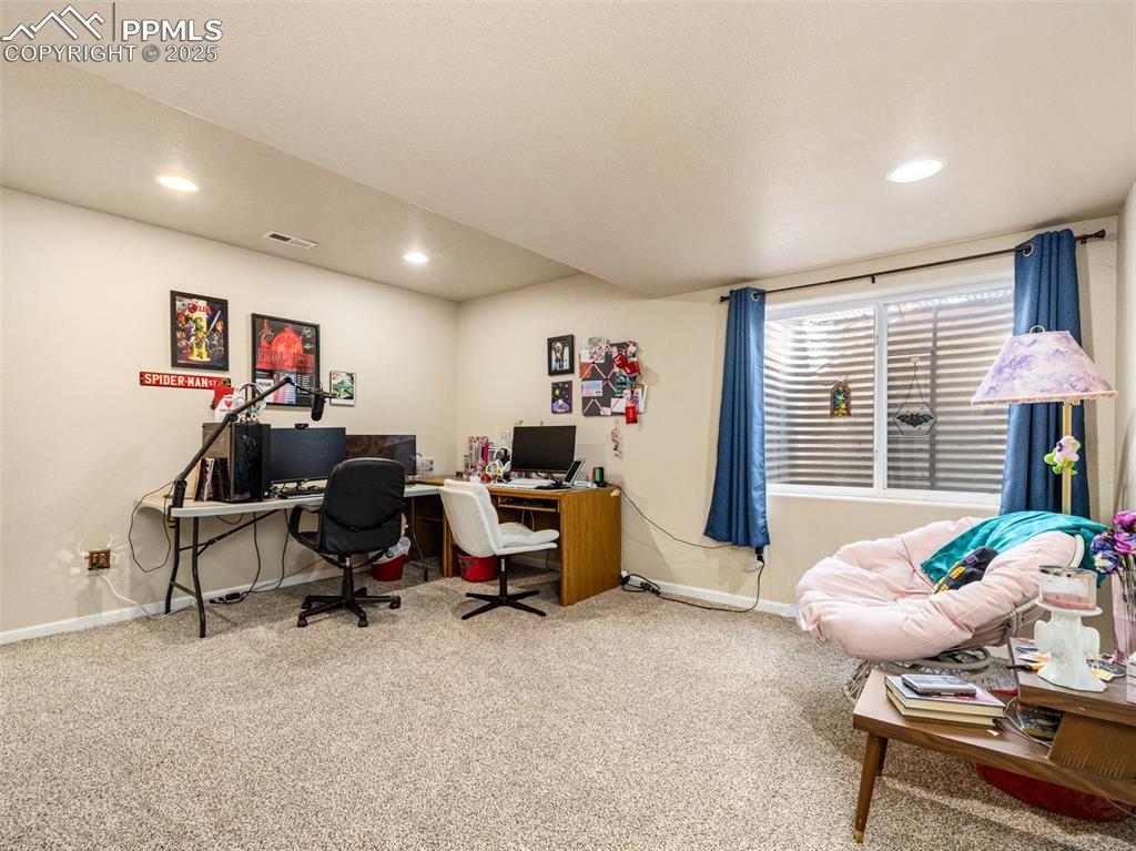 Image 32 of 48: Home office with carpet floors and recessed lighting