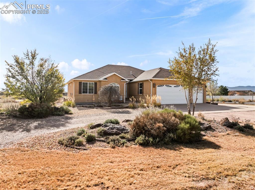 Image 37 of 48: Single story home with driveway, stucco siding, and a garage
