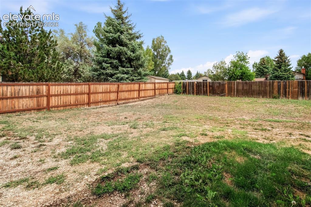 Image 33 of 35: Fenced back yard
