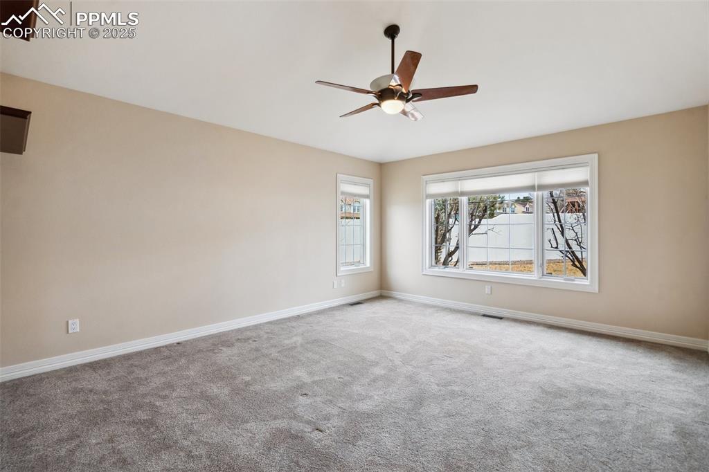 Image 16 of 49: Unfurnished room with baseboards, ceiling fan, visible vents, and carpet