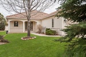 Image 2 of 49: Back of property with a lawn, stucco siding, and a tile roof