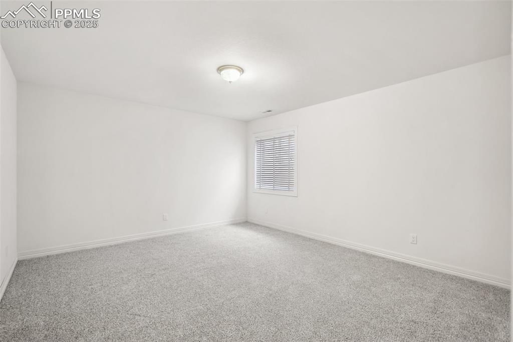 Image 29 of 49: Empty room featuring baseboards and carpet floors