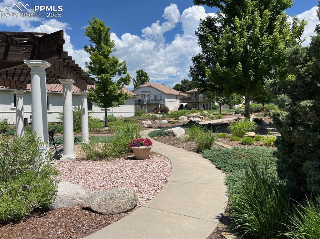 Image 44 of 49: View of community featuring a pergola and a residential view