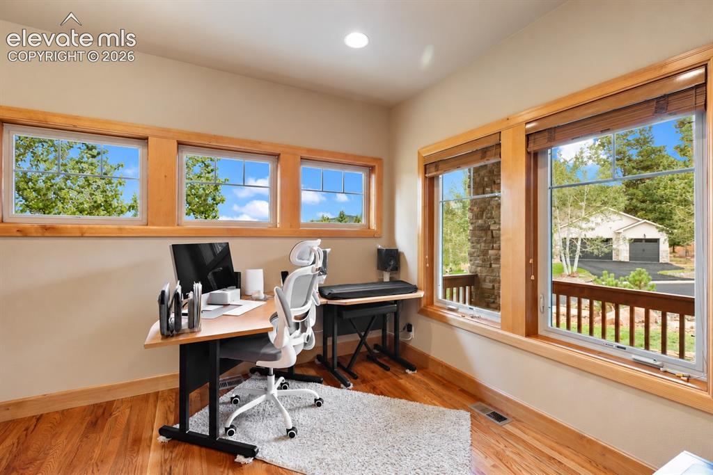 Image 12 of 24: Second main level bedroom.  Currently used as an office. 